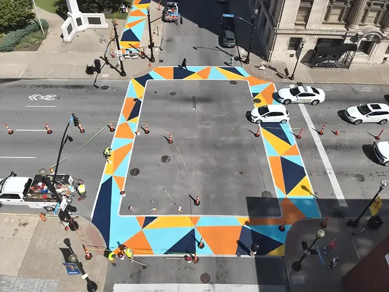 Aerial view of an intersection with a multicolored geometric crosswalk design